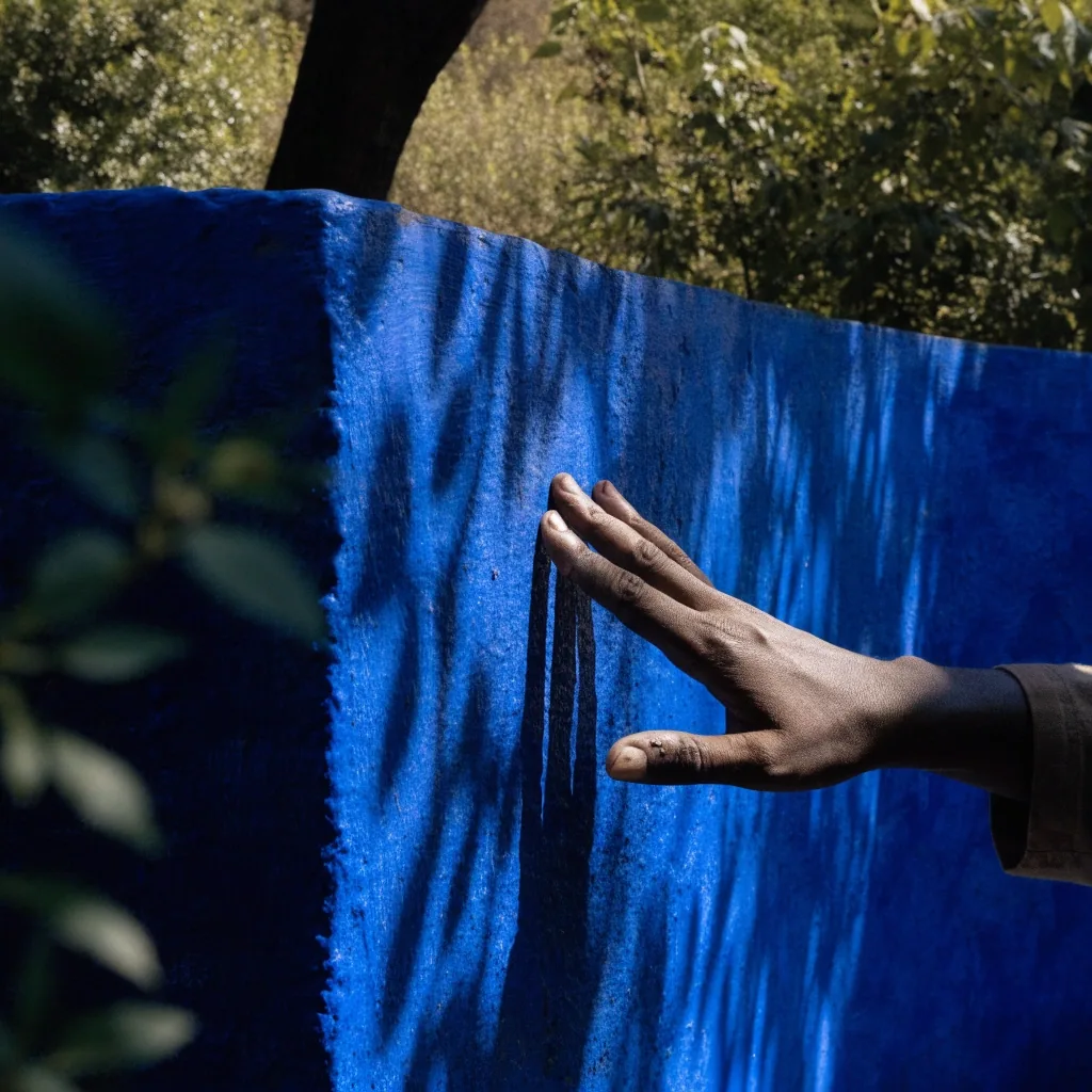 Macro detail of the cobalt blue painted wall at the Majorelle Garden in deep shade